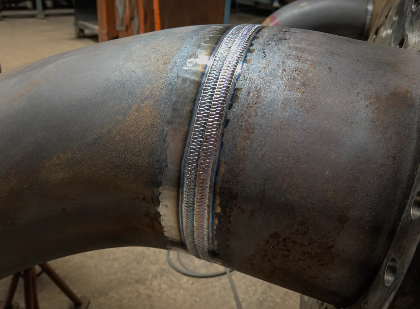 Close view of two parallel weld beads.