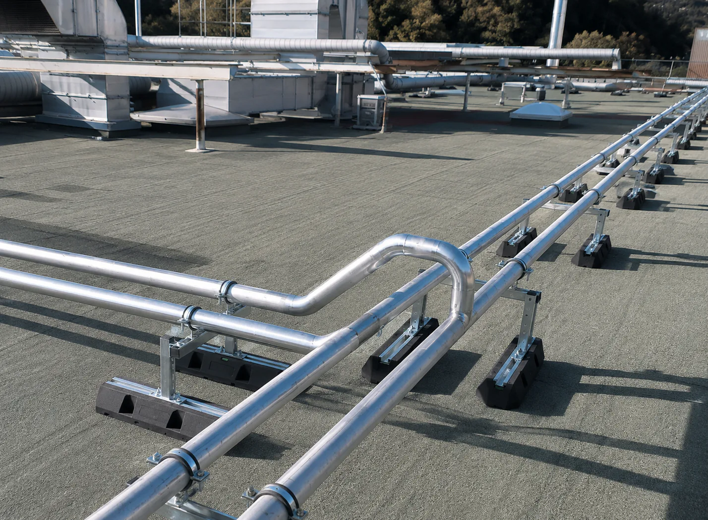 Metal pipes arranged across a rooftop.